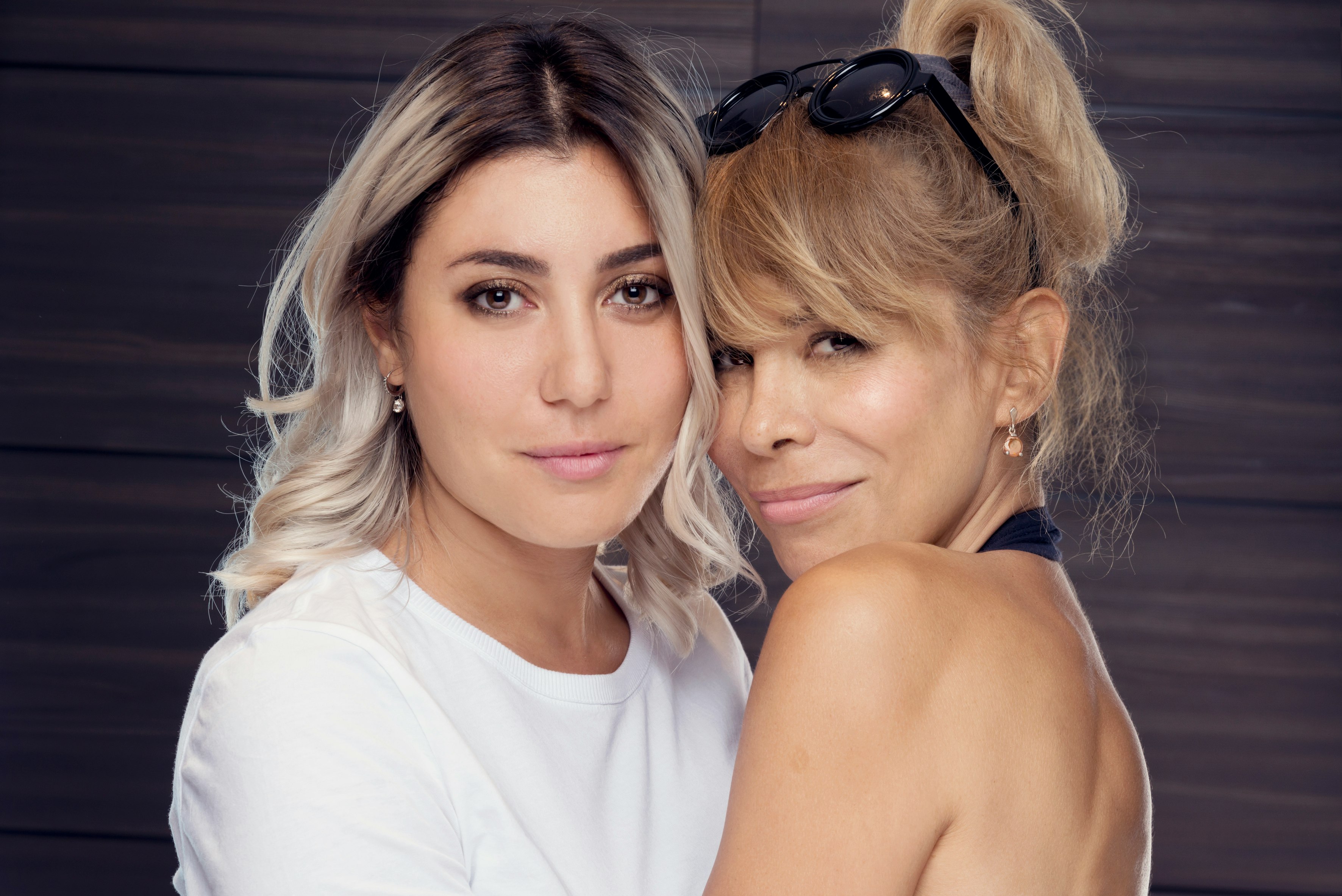 woman in white shirt beside woman in blue tank top